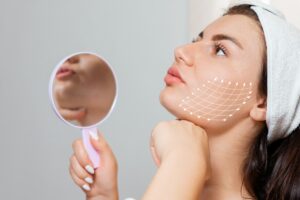 A woman looking above holding a mirror while showing the benefits of PDO Threads